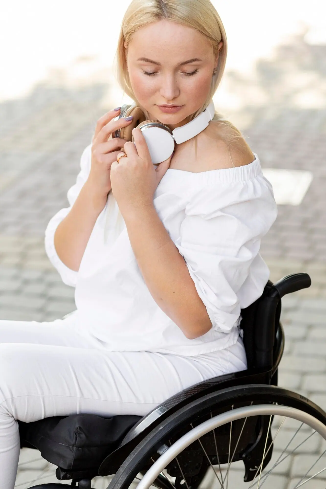 Side view of a woman in a wheelchair wearing headphones